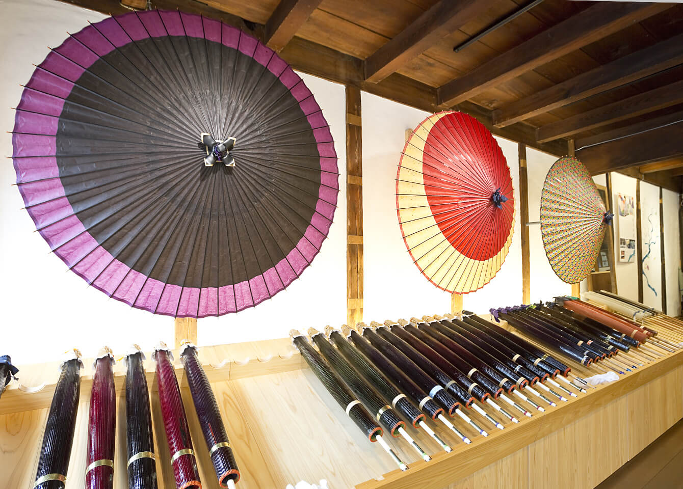 In the shop they display coarse oilpaper umbrellas, bulls-eye design umbrellas, and parasols